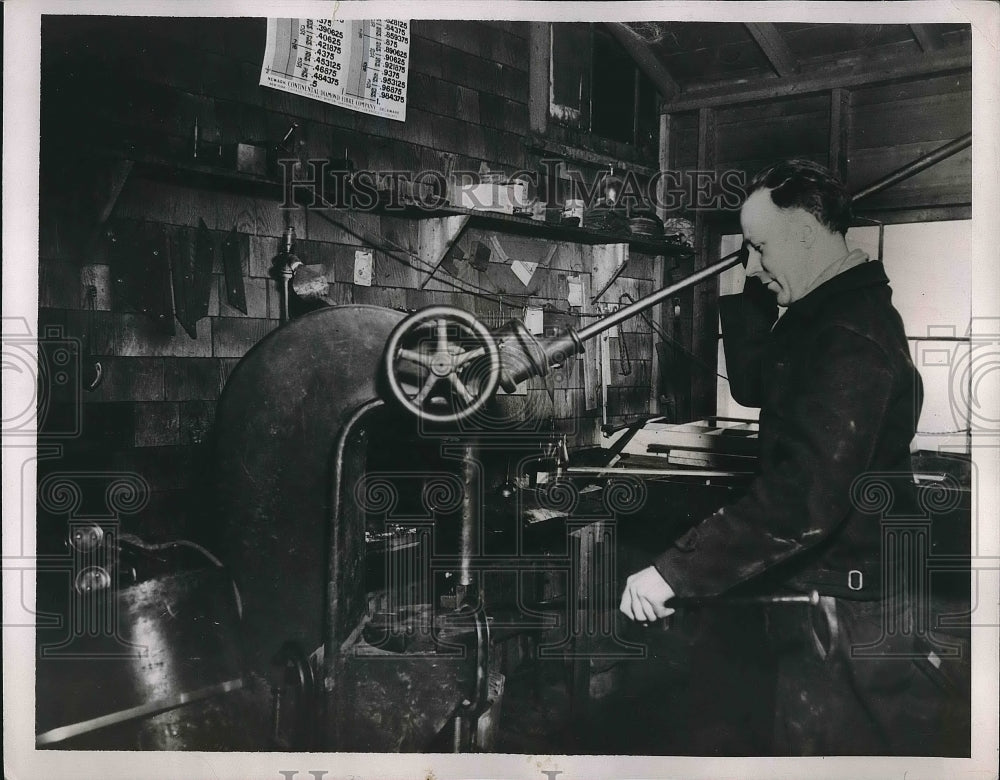 1937 Donald Huckle at a lathe making outriggers for a boat - Historic Images