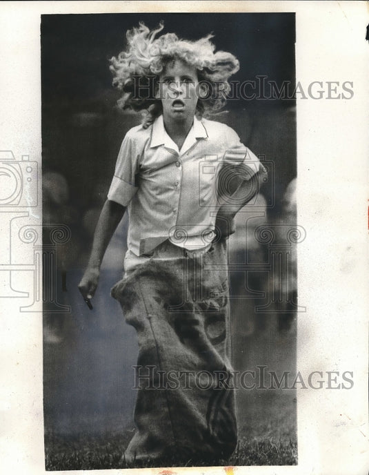 1969 Mary Harris in sack race, 4th of July festival in Greensboro - Historic Images