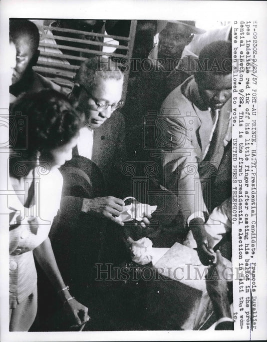 1957 Press Photo Presidential Candidate Francois Duvallier wipes red indelible - Historic Images