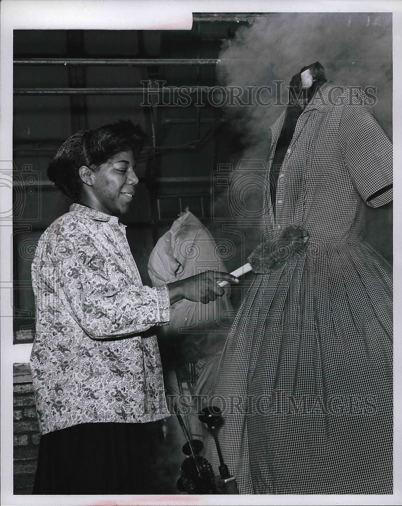 Press Photo Goodwill Worker in Training Presses Clothes With Suzie &quot;Q&quot;. - Historic Images