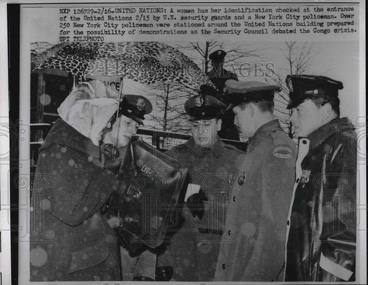 1961 Press Photo Woman has her Identification checked by U.n. Security guards - Historic Images