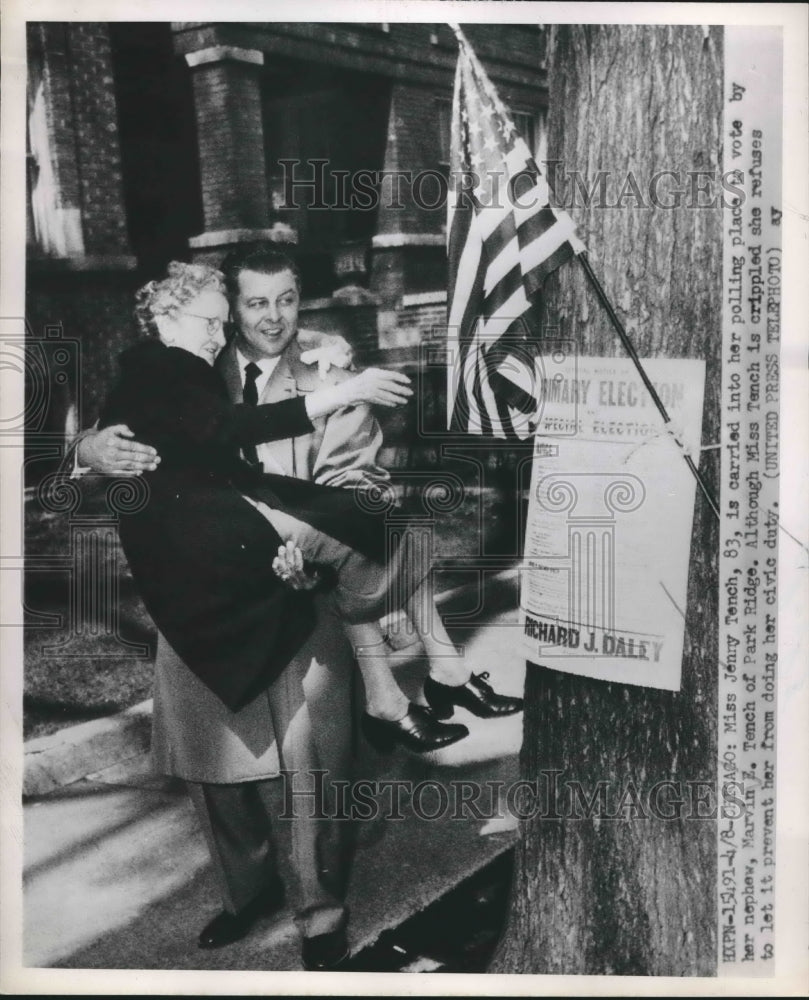 1952 Press Photo Crippled Jenny Tench carried by her nephew to polling place. - Historic Images