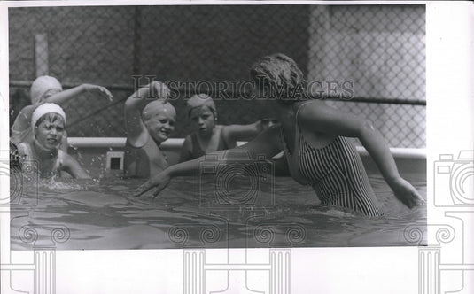 1967 Swimming Instructor Marcia Shideler with her students. - Historic Images