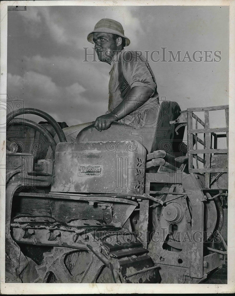1941 Pvt Leroy Sell of 112th Engineers on a bulldozer  - Historic Images