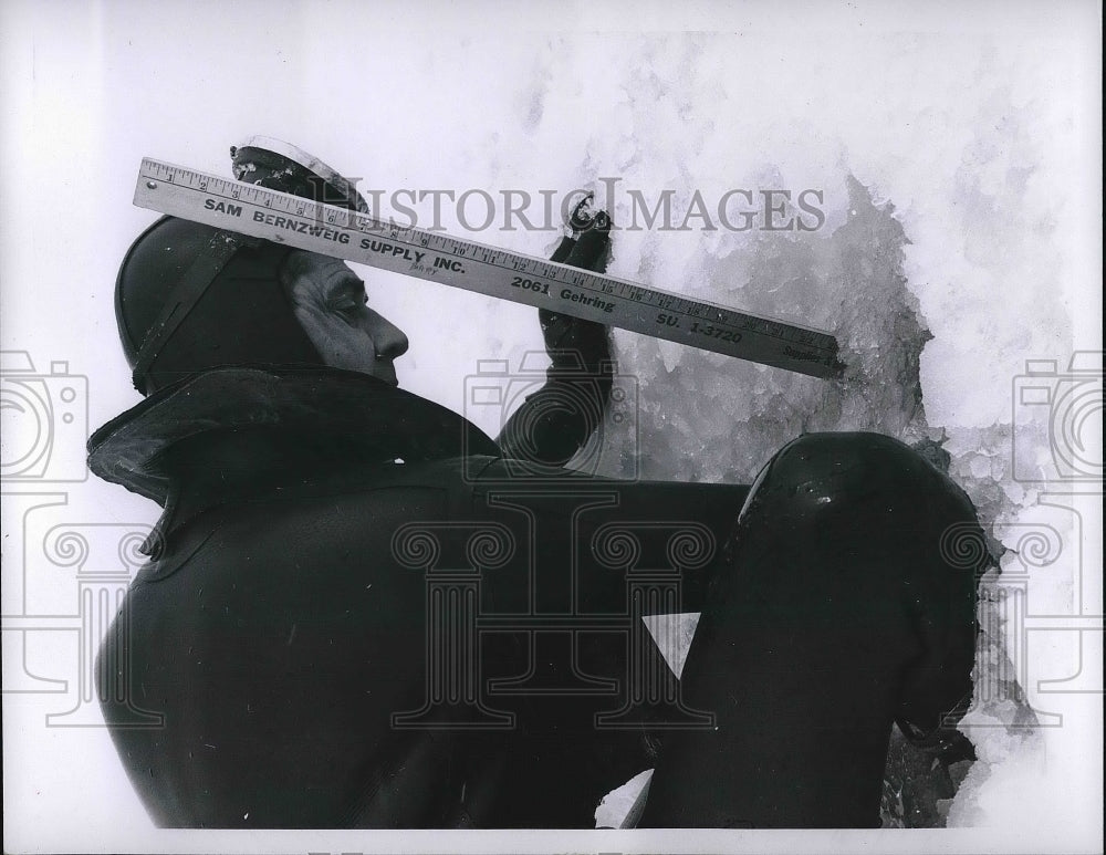 1966 Cleveland, Ohio man measures the depth of new snow  - Historic Images