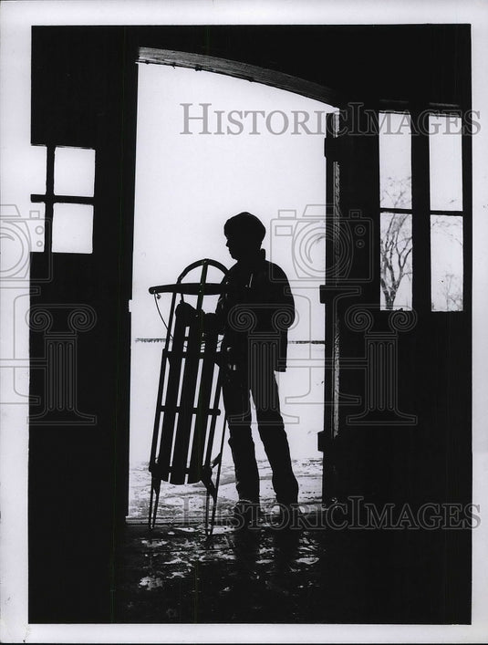 1970 Young boy & a sled to play in the snow  - Historic Images