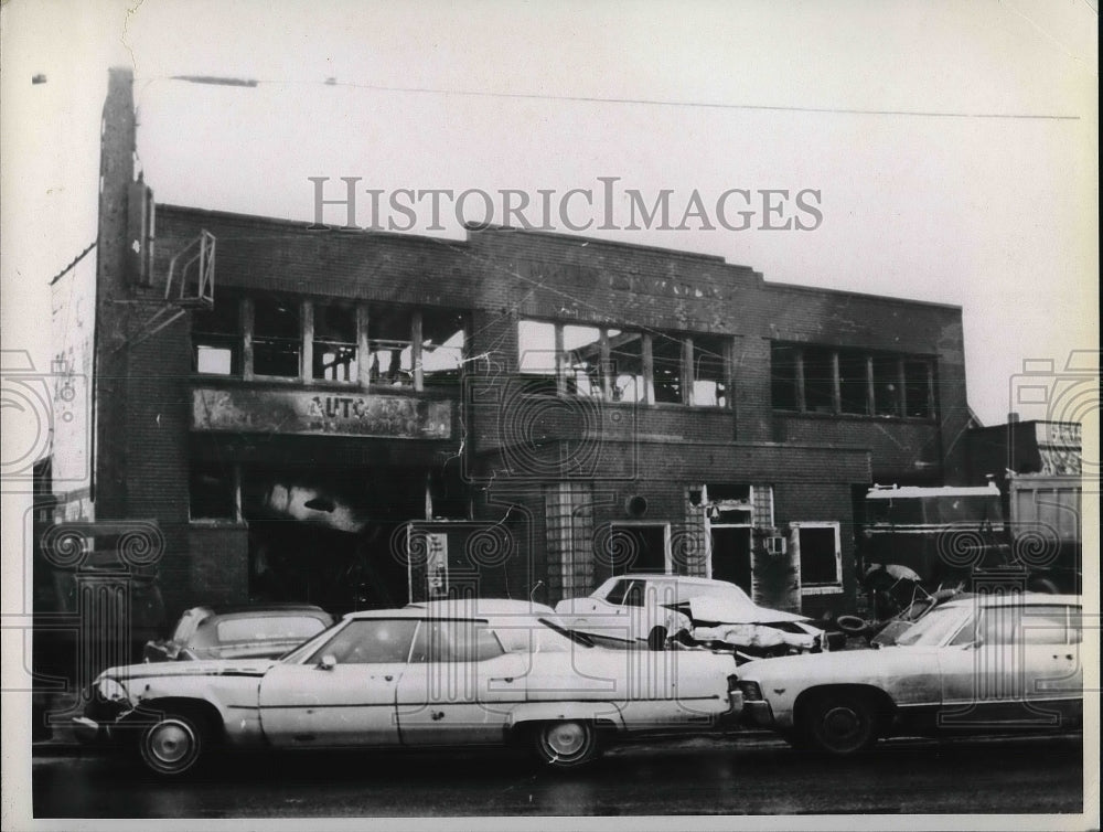 Auto accident in front of a burned out building  - Historic Images