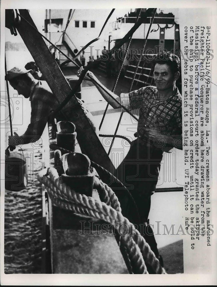 1959 Press Photo Two crewmen aboard the marooned freighter Pacific Conqueror - Historic Images