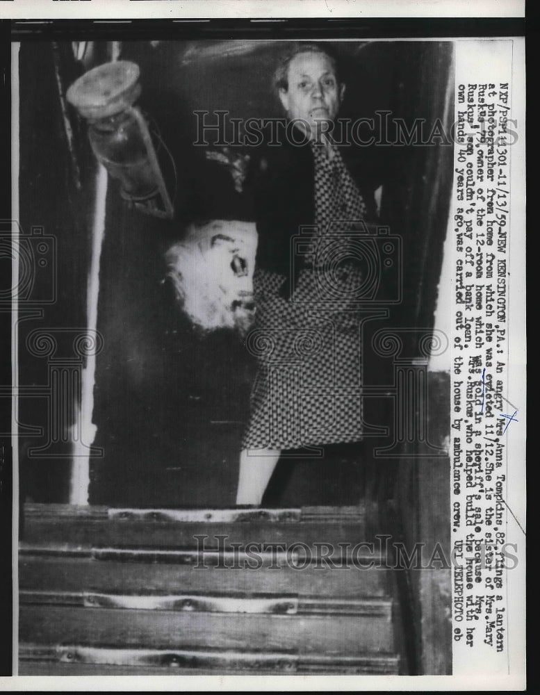 1959 Mrs.Anna Tompkins,flings a lantern at a Photographer. - Historic Images