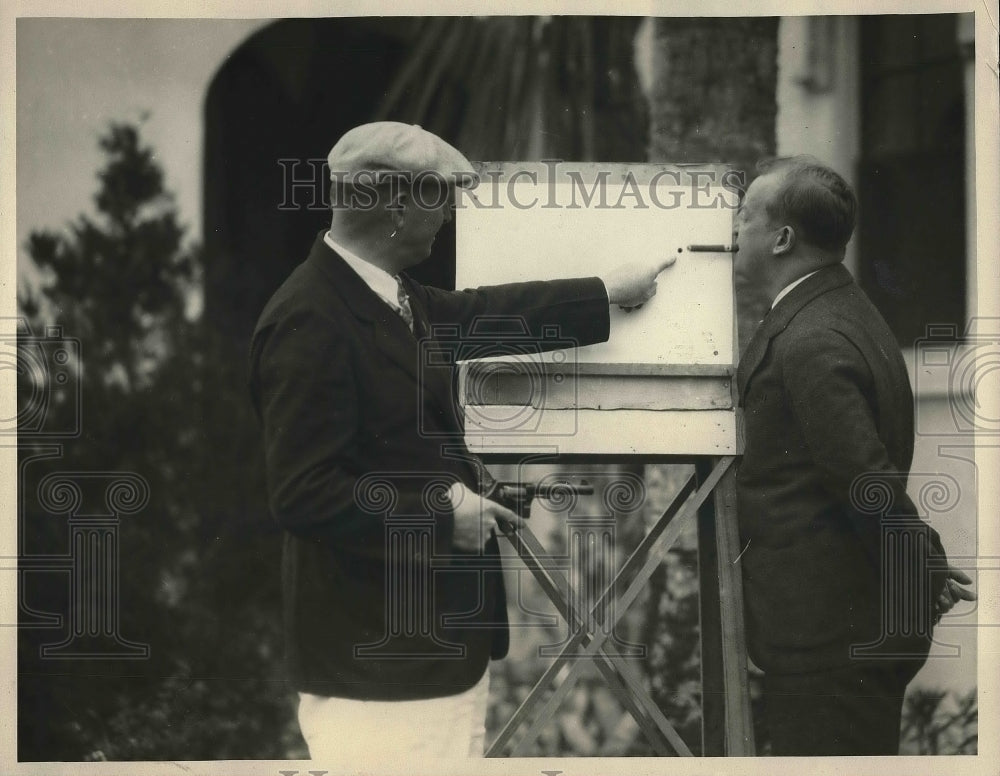 1929 Press Photo Jack Hessian Shoots Ashes from Roy Baker&#39;s Cigar - nea97152-Historic Images