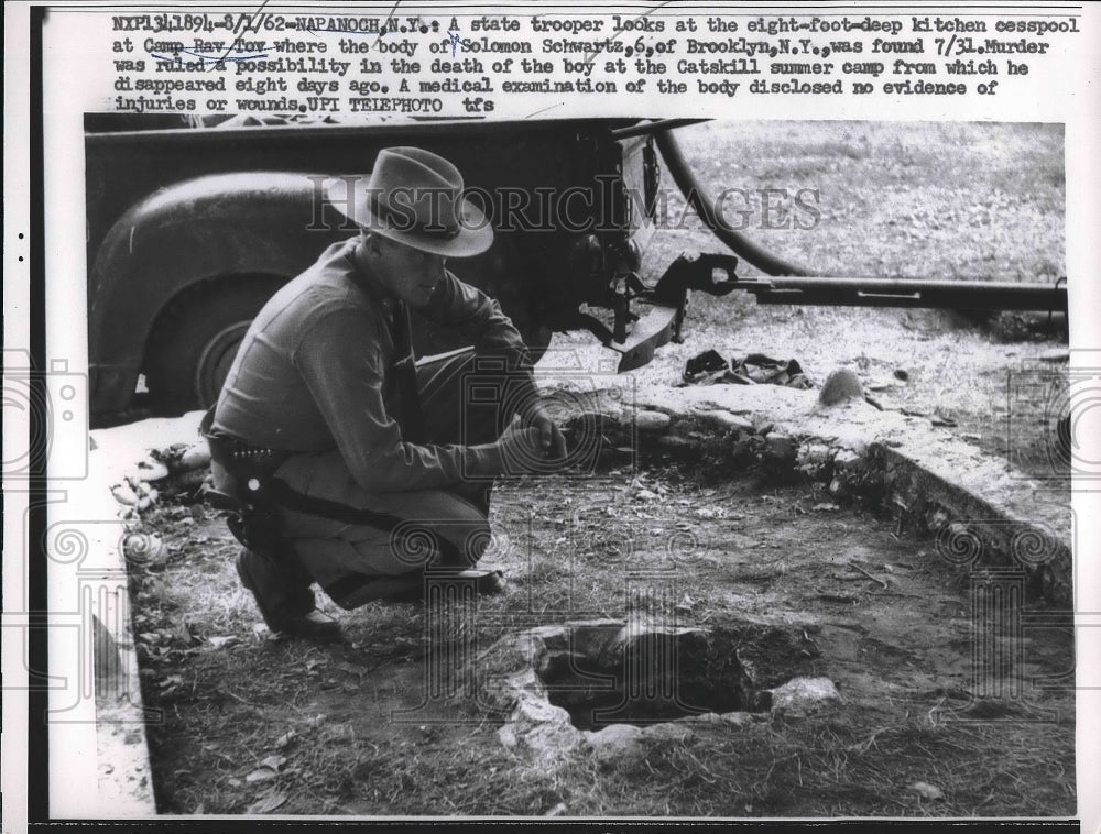 1962 A state trooper looks at the 8 - Historic Images