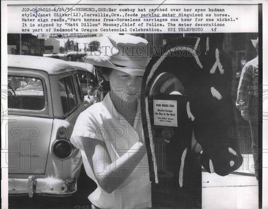 1959 Janet Oliver feeds parking meter disguised as a horse - Historic Images