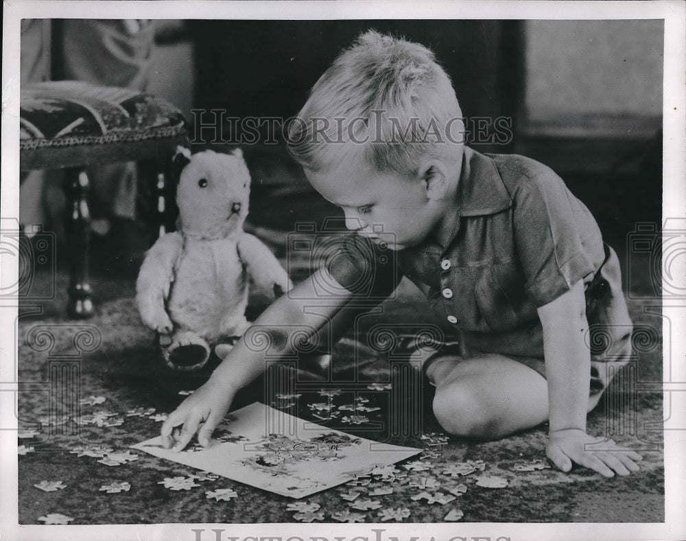 1954 Neville George Playing Jig Saw  - Historic Images