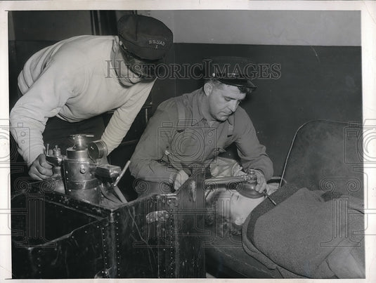 1946 Lorraine Voight 1 of the bus passengers receiving inhalator - Historic Images