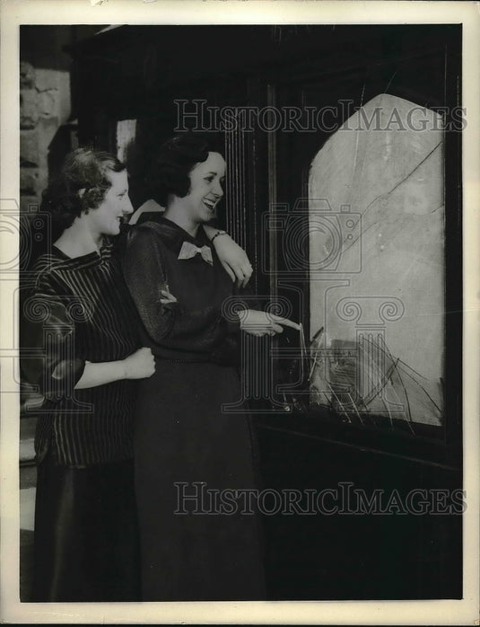 1935 Josephine Santow and Edith Carole inspecting damage done by - Historic Images