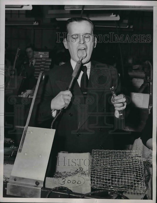 1946 Ted Kaufman compare molten lead from soldering Iron. - Historic Images
