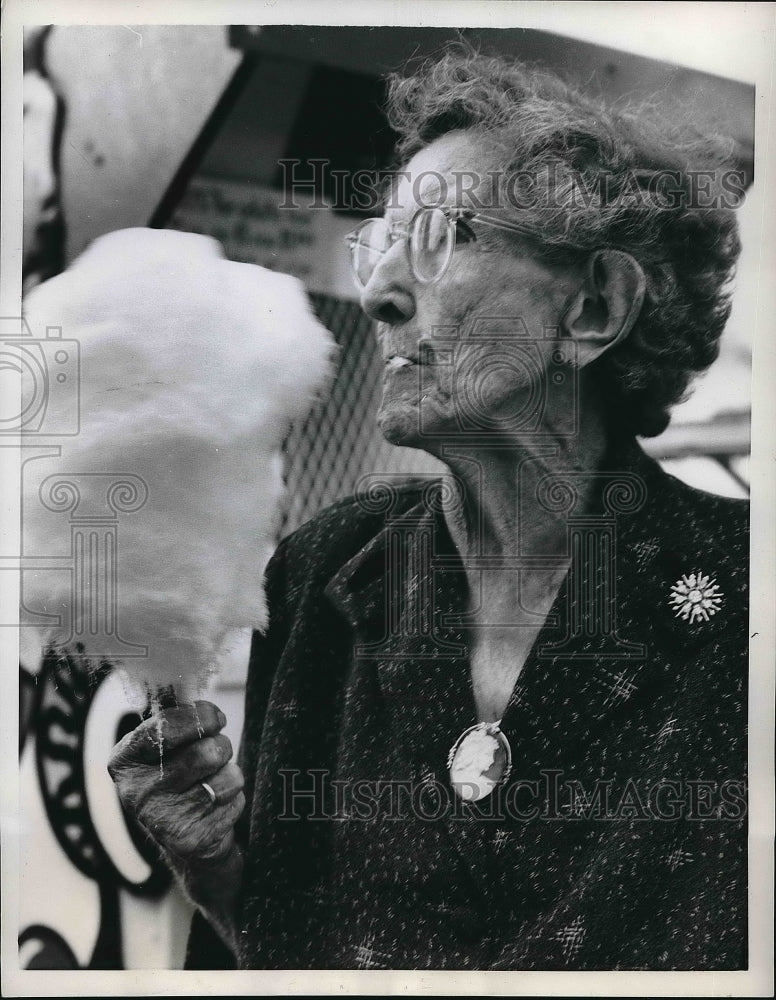 1939 Mrs. J.E. Kennedy eating cotton candy  - Historic Images