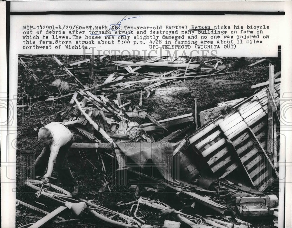 1960 Press Photo Barthel Betzen picks up his bicycle Tornado Debris - Historic Images