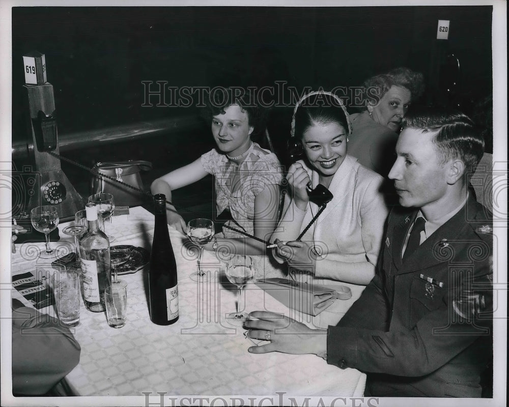 1952 Women % a military man at a cafe having a drink - Historic Images