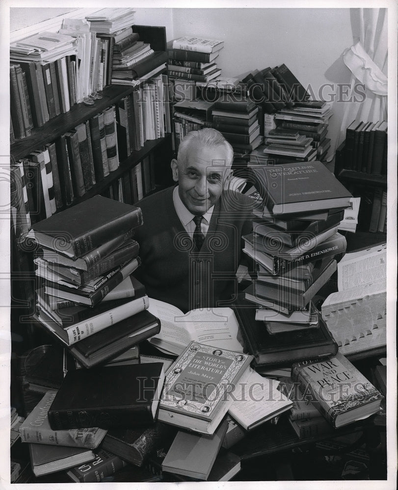 1957 Press Photo Edward Paul showing off his book collection after retiring - Historic Images