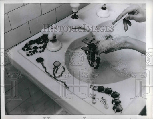 1956 Press Photo Costume Jewelry around a sink-Historic Images
