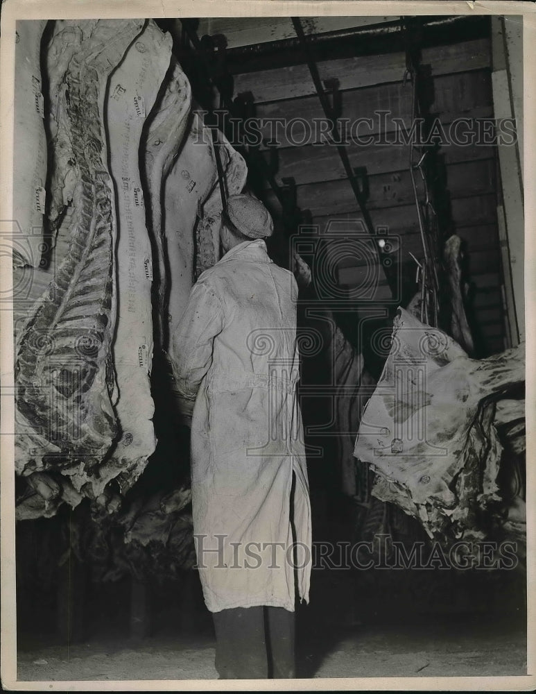 1939 Worker in a beef factory cooler - Historic Images