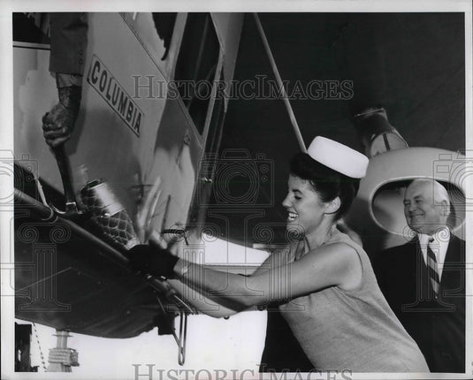 Jacquelyn Meyer Breaking Bottle On Machine-Historic Images