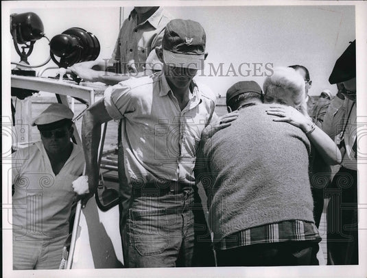 1967 Kenneth Trimmell with wife after being rescued by Coast Guard - Historic Images