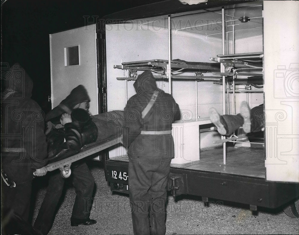 1939 Rescuers placing victim in an ambulance - Historic Images