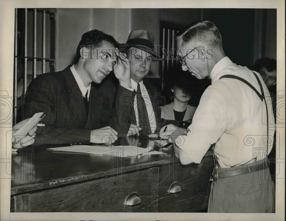 1947 Press Photo Paul Rene Refoule is booked for strangling his wife - neb11941 - Historic Images