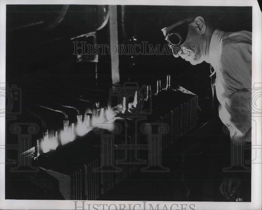 1952 Man with goggles looks at flames - Historic Images