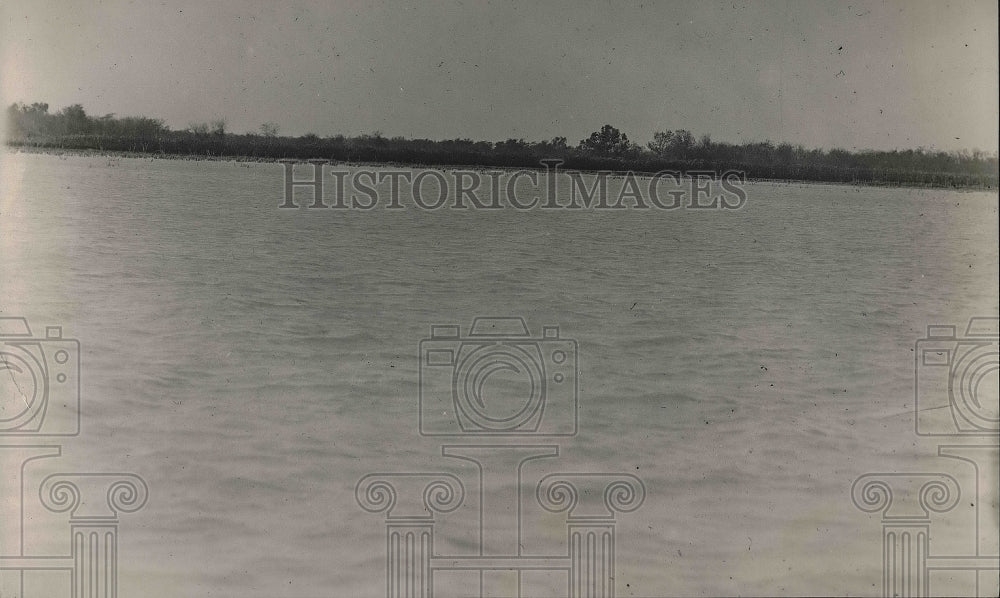 1920 Press Photo A lake with a forest in the background.-Historic Images