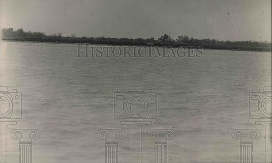 1920 Press Photo A lake with a forest in the background.-Historic Images