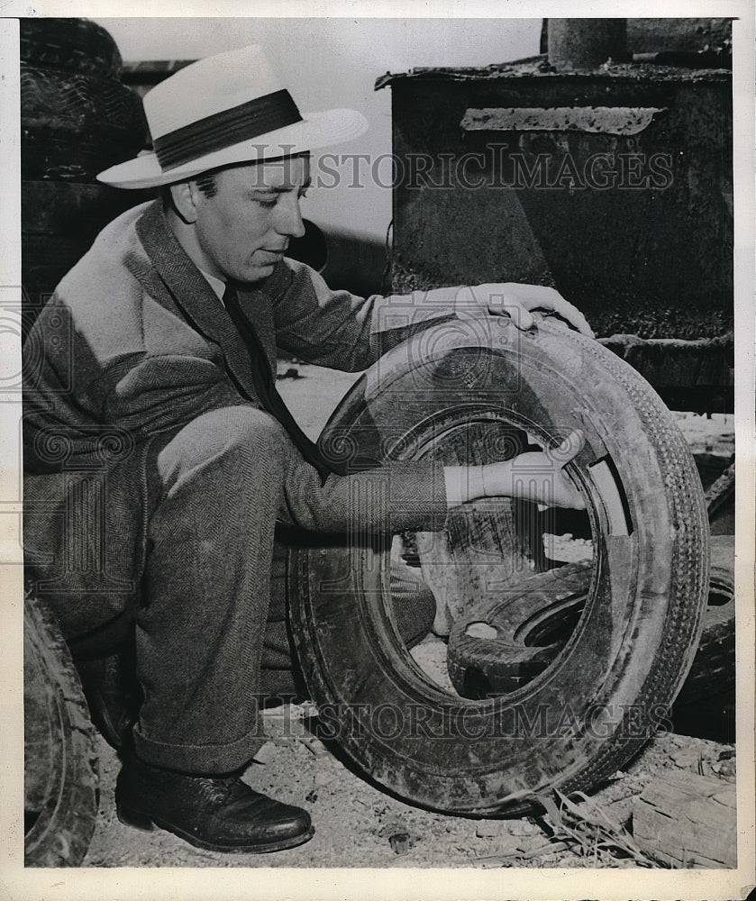 1942 Press Photo Charles Stephens, Jr. shows oblong hole in tire - neb19062 - Historic Images