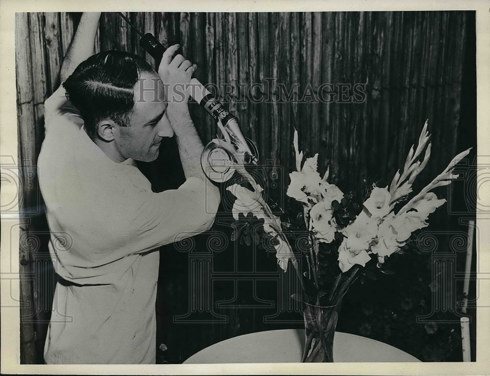 1939 Press Photo Chemist Eric Eichwald demonstrating out door spray - Historic Images