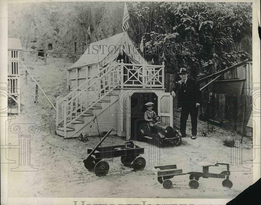 1925 J.A. Widner while his grandson James Chappel plays - Historic Images