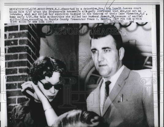1960 Mrs. Ann Lupoli, being escorted by a detective after - Historic Images