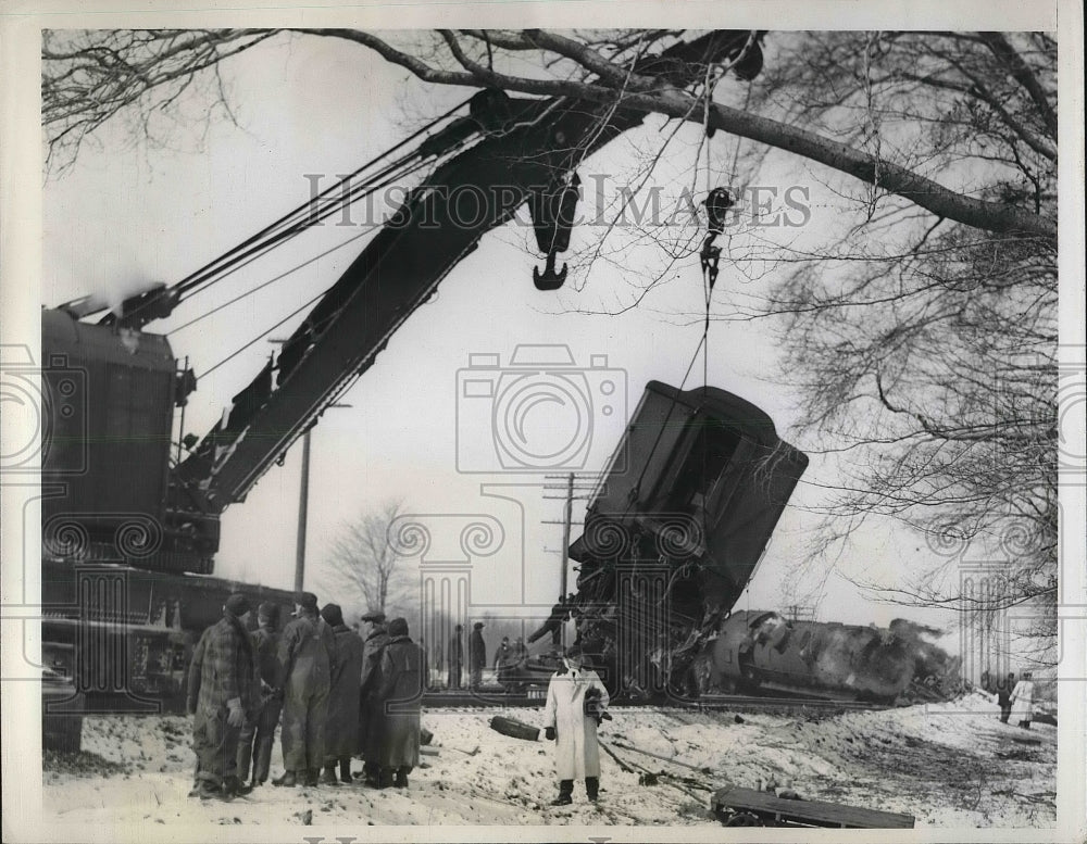 1941 Hoisting one of four overturned cars back onto the track, a big-Historic Images