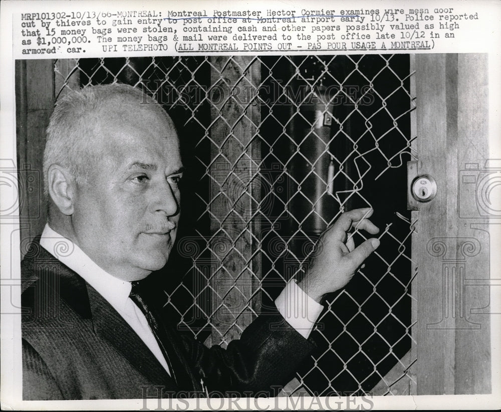 1966 Press Photo Montreal Postmaster Hector Cormier examine wire cut by thieves. - Historic Images