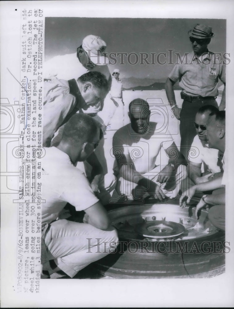 1962 Dr. Nathan Ostich examining wreckage - Historic Images