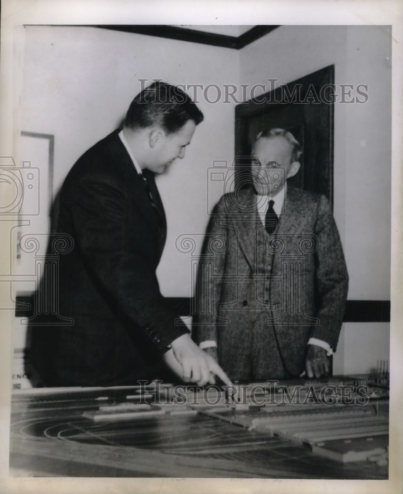 1944 Henry Ford 2nd looks over table model of one of the Ford-Historic Images