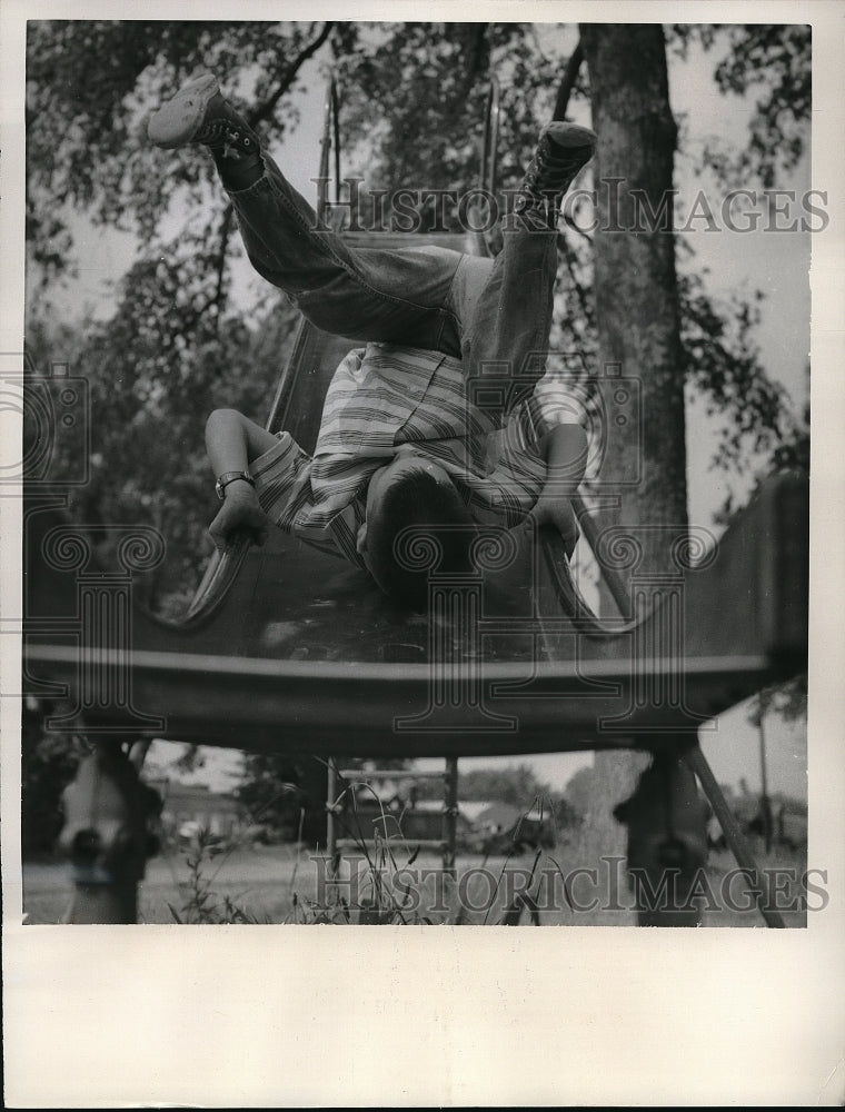 1961 Press Photo Michael Fesler of Little Rock, Arkansas slide upside down. - Historic Images