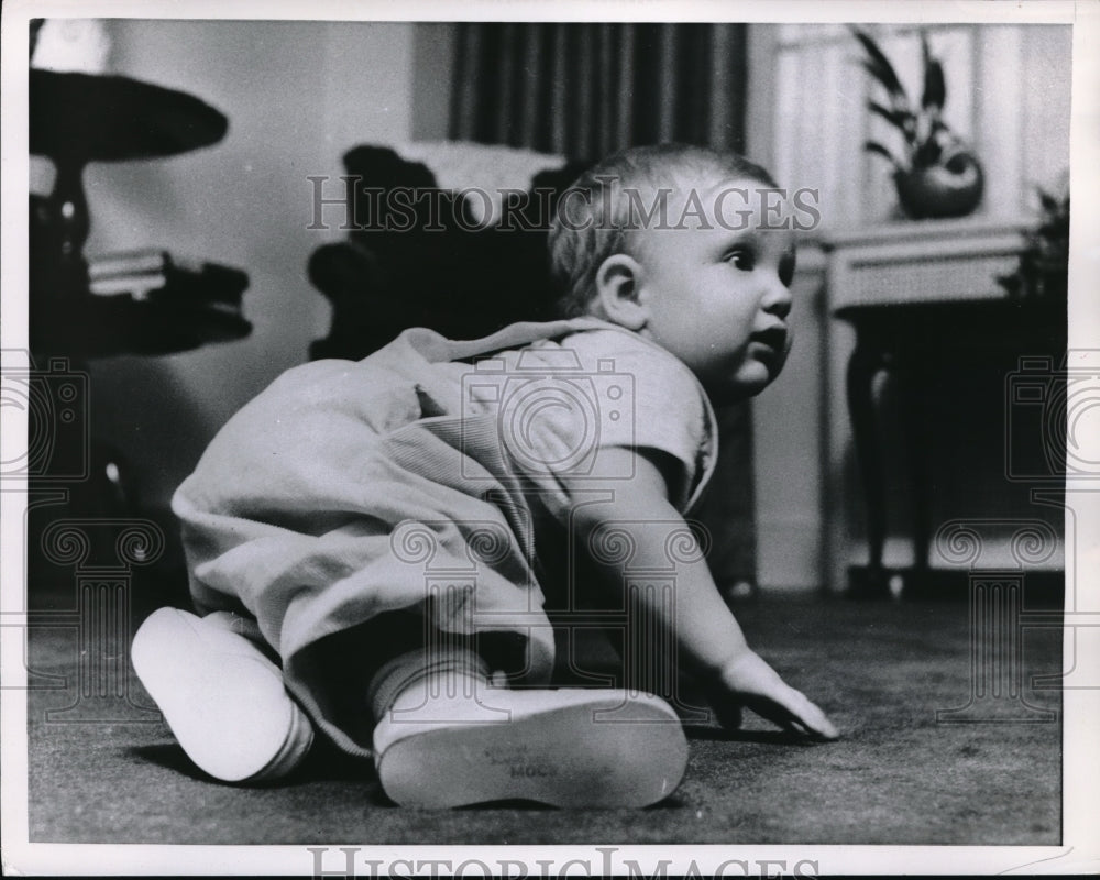 1956 Baby wearing baby shoes - Historic Images