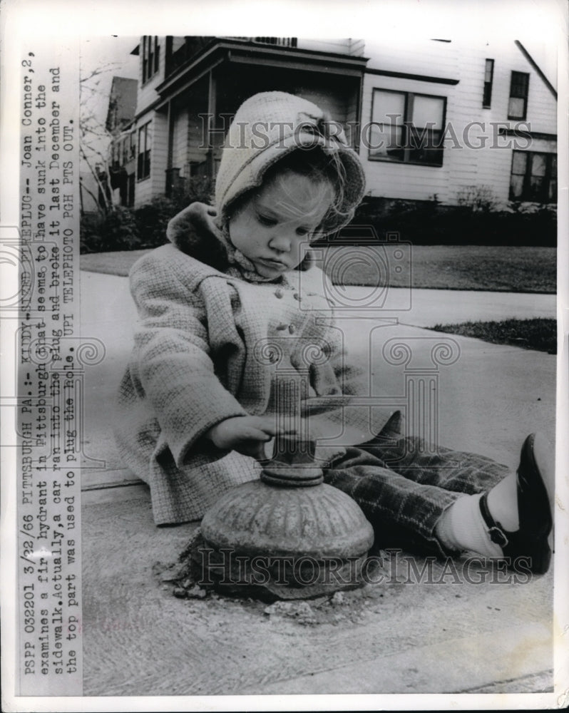 1966 Press Photo Joan Conner examines a fir hydrant in Pittsburgh - Historic Images