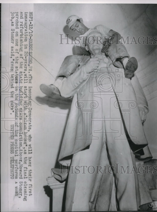 Howard Stoner take the final cleaning of Statue in State Building. - Historic Images