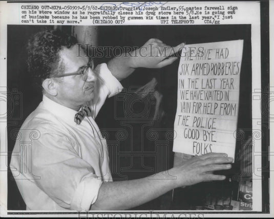 1962 Druggist Joseph Endler posts farewell sign in store window - Historic Images