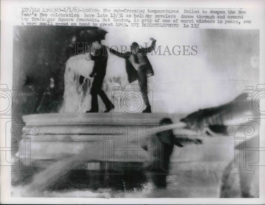 1963 New Year's Eve Celebration around icy Trafalgar Square Fountain - Historic Images