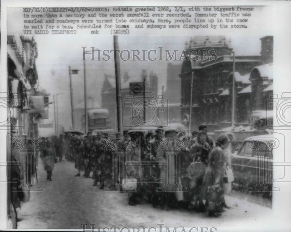 1962 London England people in line for a bus in snowstorm - Historic Images