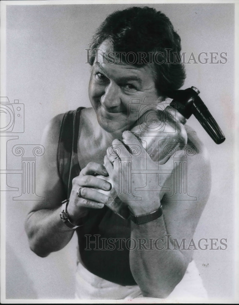 Press Photo Man holding metal bottle - Historic Images