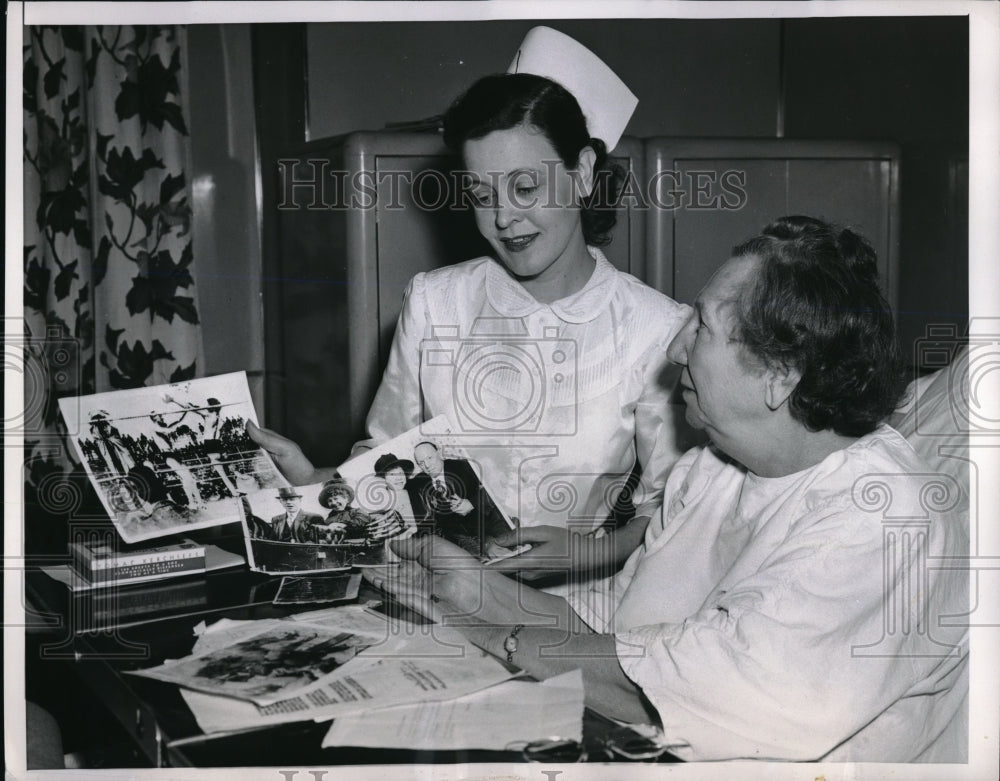 1953 Bob Fitzimmons Looks Over Their Photos Of His Wife - Historic Images